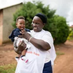 A CHW sensitizes community members about keeping good health and how to prevent childhood diseases.